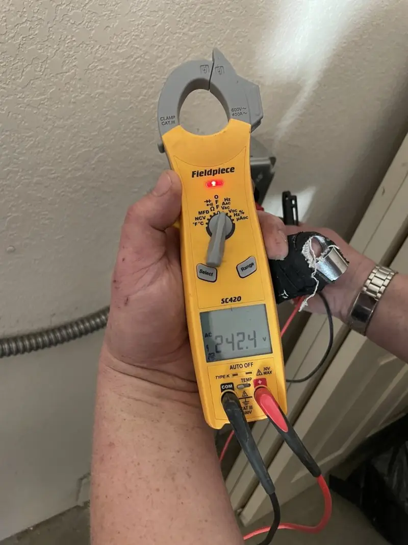 Voltage testing with clamp meter during Whole House Surge Protector in Ensley